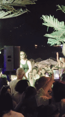 Live outdoor night show with performers, crowd, and celebrations