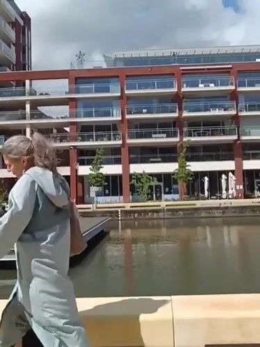 Pedestrians and cyclists share bridge walkway in Leuven