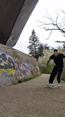 Man performs backflip near graffiti wall in Varna