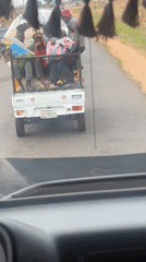 Loaded pickup truck carries passengers on Nigerian road