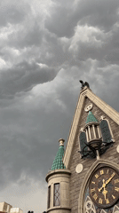 Moscow castle-style clock tower under a stormy sky