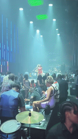 Crowded nightclub dance floor under colored lights in Abuja