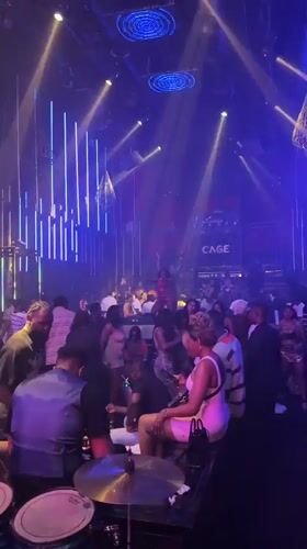 Crowded nightclub dance floor under colored lights in Abuja