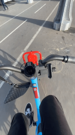 Cycling past the Eiffel Tower on a Paris bridge