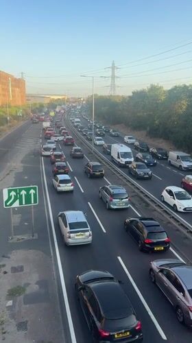 London highway gridlocked under a late-afternoon sun