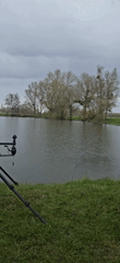 Rainy day fishing setup at rural lake in France