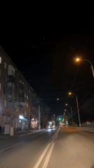 Nighttime urban street captured from moving vehicle perspective