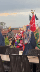Historical costume group parades through Edirne as local cat watches