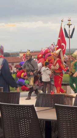 Historical costume group parades through Edirne as local cat watches