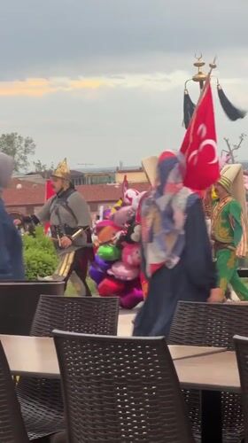 Historical costume group parades through Edirne as local cat watches