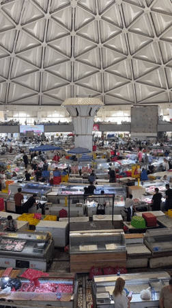 Morning market activity documented in Tashkent's indoor bazaar