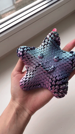 Person demonstrates colorful 3D-printed fidget toys in Noviy, Russia