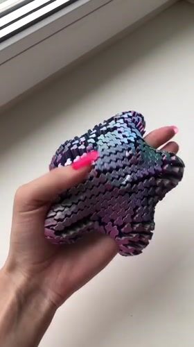 Person demonstrates colorful 3D-printed fidget toys in Noviy, Russia