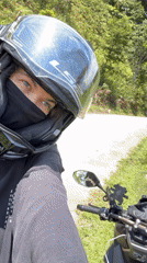Masked motorcyclist documented in early morning Huế mountain landscape