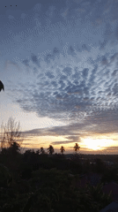 Dawn breaks over Lhokseumawe with layered clouds and golden horizon