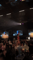 Woman in red leotard dances on bar at Plovdiv nightclub