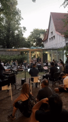 Musicians perform outdoor concert in Buenos Aires garden at dusk
