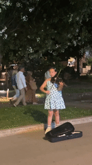 Street musicians perform amid yacht-filled evening in Budva, Montenegro