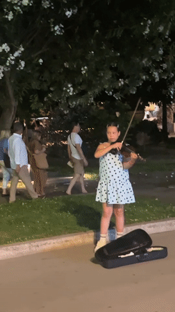 Street musicians perform amid yacht-filled evening in Budva, Montenegro