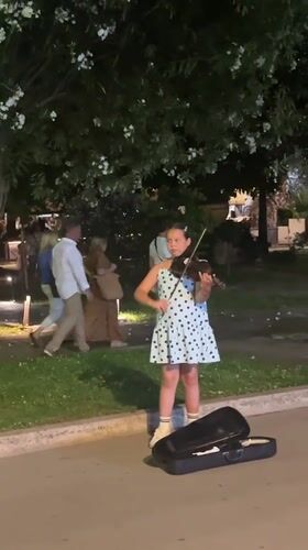 Street musicians perform amid yacht-filled evening in Budva, Montenegro
