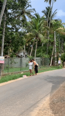 Two women stand on roadside in Kabalana, Sri Lanka