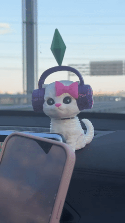 Driver with novelty bobblehead travels sunny Russian highway