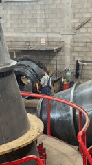Metalworkers grind large structures at Montenegro industrial shop