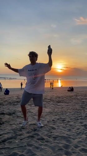 Tourists enjoy sunset, shopping, surfing in Kuta Indonesia
