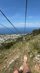 Tourist rides Monte Solaro chairlift capturing scenic Anacapri views