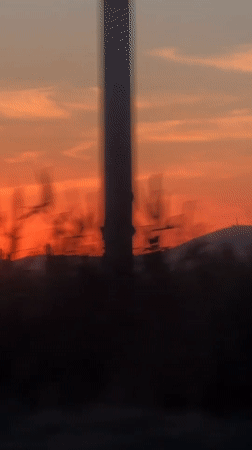 Orange sunset with airplane contrail observed in Kyrgyzstan