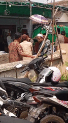 Funeral procession moves through Rambipuji village streets