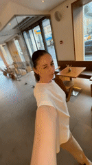 Woman takes selfie at Moscow cafe with dome view