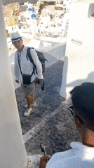 Quiet morning in Oia: ocean views, clifftop terraces, a lounging cat