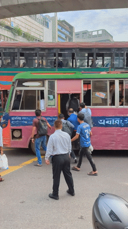 Early morning street life continues in Dhaka intersection