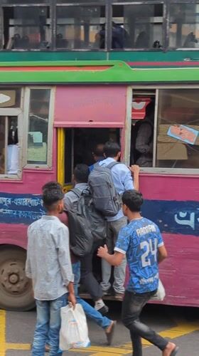Early morning street life continues in Dhaka intersection
