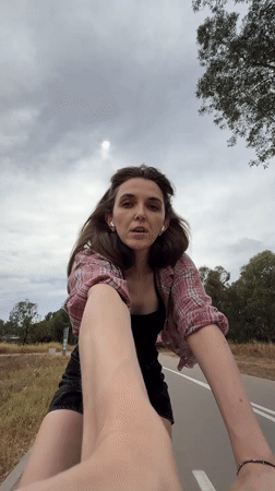 Woman films selfie while cycling in Tel Aviv