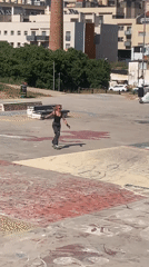Pink-haired roller skater practices tricks at Badalona skatepark