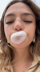 Woman blows bubblegum bubbles in close-up footage, Puebla
