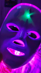 LED face mask session in a Ufa bedroom, late evening