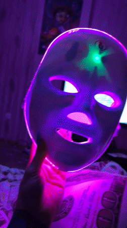 LED face mask session in a Ufa bedroom, late evening