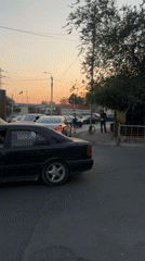 Yerevan street at dusk, pedestrian traffic and parked cars