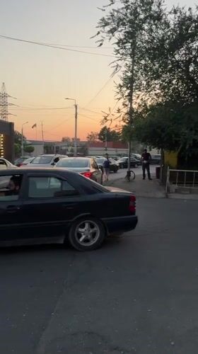Yerevan street at dusk, pedestrian traffic and parked cars