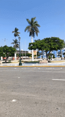 Pedestrians gather around Monument to Liberty in Trujillo's main square