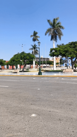Pedestrians gather around Monument to Liberty in Trujillo's main square
