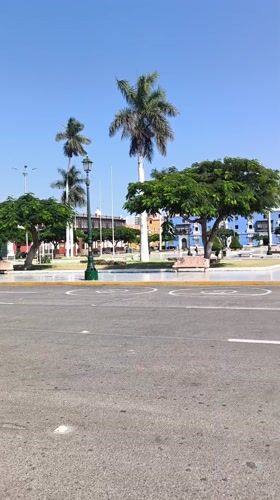 Pedestrians gather around Monument to Liberty in Trujillo's main square