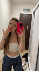 Woman takes selfie in Varna hallway mirror