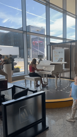 Piano on a circular stage inside a Warsaw transit hub