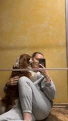Woman takes selfies with dog in Khimki apartment