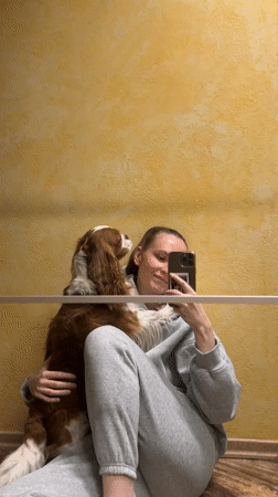 Woman takes selfies with dog in Khimki apartment