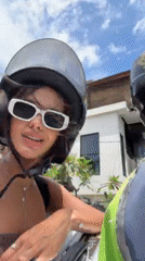 Woman documents travel content via motorbike and airplane selfies